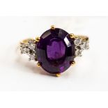 An amethyst and 18ct gold diamond dress ring, comprising an oval amethyst approx 12mm x 9mm,