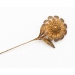 A fine gilt metal filigree work hat pin, in the form of flower with leaves and further flower verso,