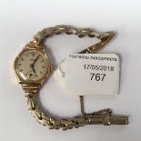 A ladies 9ct gold wristwatch, having plated strap, Arabic numerals, seconds hand,