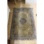 A Chinese hand knotted silk rug, having floral patterns on a cream ground, sky blue borders,