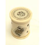 A turned, carved and stained ivory dice shaker/case and dice, 19th century.