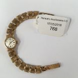 A 9ct gold Rotary bracelet watch, with round dial, fancy textured rectangular link bracelet,