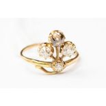 A four stone old cut diamond ring, comprising a cinnamon diamond along with three white diamonds,