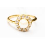 A cultured pearl and diamond cluster ring, set in yellow metal tests as 18ct gold,