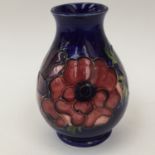 A Moorcroft baluster blue ground vase, tube lined decoration,