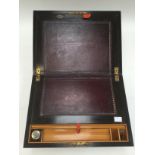 A rosewood writing slope with monogrammed cartouche to top with burgundy leather slope and one