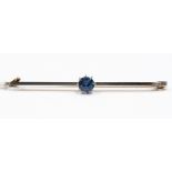 A sapphire, platinum and 15ct gold bar brooch, claw set with a round sapphire, approx length 50mm,