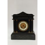 A Victorian black slate mantle clock.
