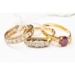 A ruby and diamond ring, oval ruby to the centre with diamonds either side, size P,