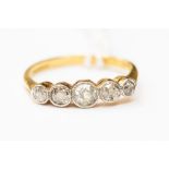 A five stone diamond ring with old cut diamonds, set with a millegrained edge in 18ct gold, size P,