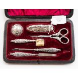 A cased manicure set, comprising six silver/silver handled pieces,