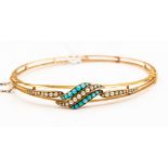 A yellow metal seed pearl and turquoise bangle, probably 14ct,