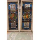 A pair of stained glass windows with centre roundels depicting flowers (2)