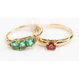 A 9ct gold ruby ladies dress ring, ring size T½; together with an emerald and diamond dress ring,