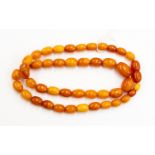 A string of Amber type beads, comprising graduated oval beads,