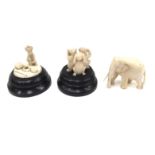 An ivory elephant and two ivory figure groups on stands (3)