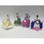 Four Royal Doulton figures, Ninette HN 4717, Christmas Day HN 4757, Autumn Breeze,