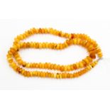 An amber bead necklace, Butterscotch beads with a hook and loop clasp,