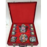 An early mid 20th Century Chinese red landscape box cased 15 piece tea set of millifleur blue