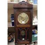 A 1940s oak cased drop dial clock,