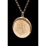 An Edwardian yellow gold circular locket, engraved monogram to the front M A, stamped 15ct,