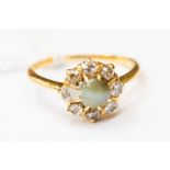 A Victorian old cut diamond and cats eye chrysoberyl cluster ring, claw set in yellow metal,