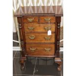 A late Victorian mahogany miniature chest of drawers,