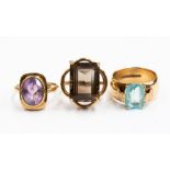 Three 9ct gold rings, one set with cushion shaped blue topaz,