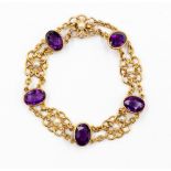 An amethyst and pearl bracelet with fancy gold open flower links set to the centre with small