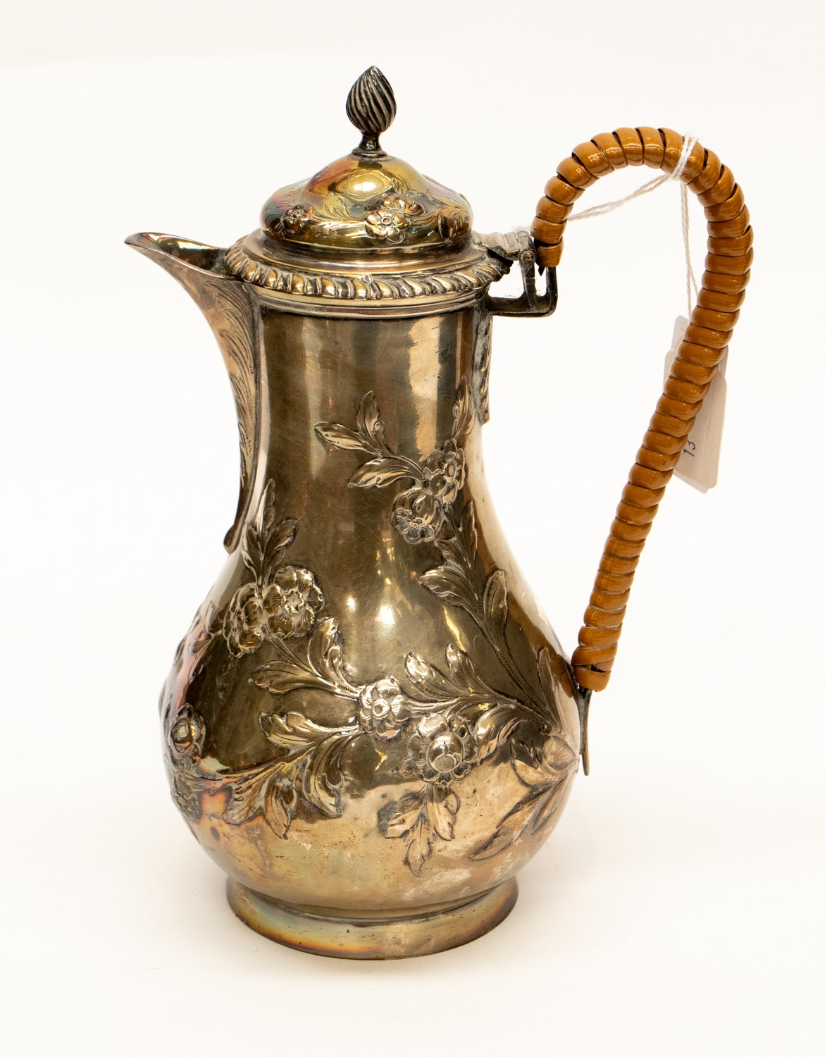 A silver hot water/milk jug with bound handle, repouse rose and leaf design, gross 14.