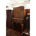 A cabinet, twin opening doors to top with two drawers beneath,