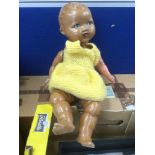 A late 1940s, doll of colour, possibly German composition, with replaced arm, painted features,