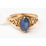 A 9ct gold ring set with a oval triplet opal, with open mount, size K,