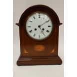 A George V mahogany and boxwood inlaid eight day mantle clock,