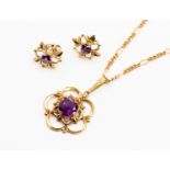 An amethyst pendant with a floral design, set with a round amethyst to the centre, set in 14ct gold,