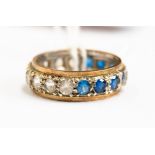 A full eternity ring set with half blue and white stones, size K 1/2,