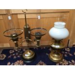 A brass twin burner oil lamp;