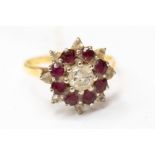 An 18ct gold diamond and ruby cluster ring, centre diamond approx 0.