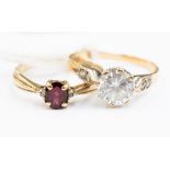 Two 9ct gold rings, comprising a single stone garnet ring with diamond set shoulders,