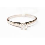 An 18ct white gold solitaire diamond ring, claw set with Hearts of Five diamond,