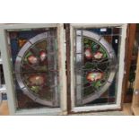 A pair of stained glass windows with an arch shaped design and floral decoration (2)