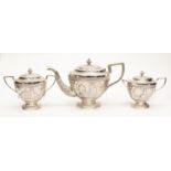 Indian silver teapot, milk, sugar, with covers, heavily embossed, weighing approx 41.