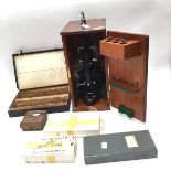 A cased microscope circa 1930s with lock and additional lens plus Leeds university slides -