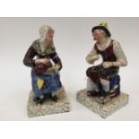 A pair of Staffordshire Prattware figures of Peasant man and woman,