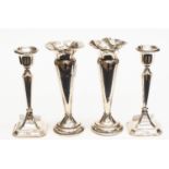 A pair of silver specimen vases; together with a pair of silver candlesticks,