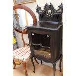 A late Victorian ebonized music cabinet, fitted with a single glazed door,