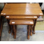 A solid oak nest of three tables,