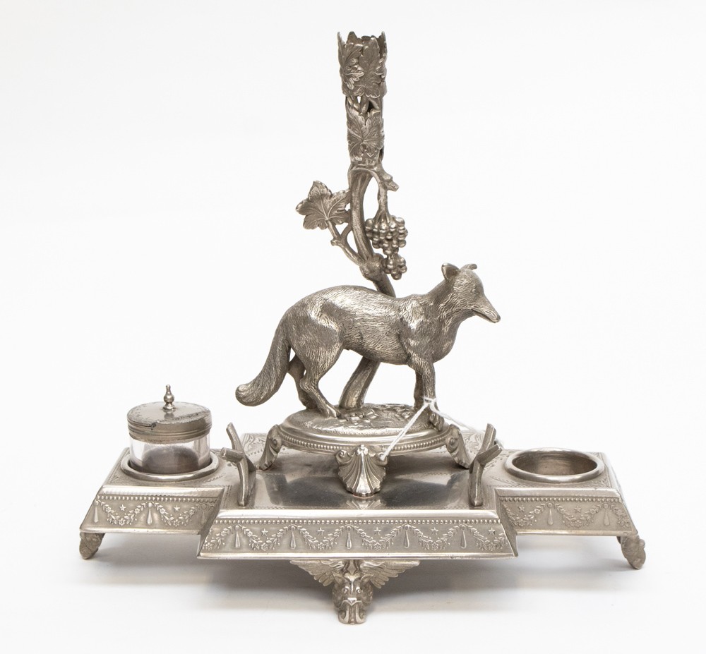 A silver plated desk stand with central fox and space for two ink pots,