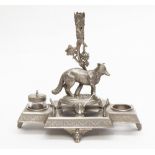 A silver plated desk stand with central fox and space for two ink pots,