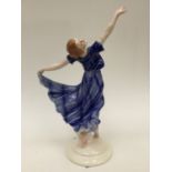 A continental Art Deco style figure of an elegant lady in blue evening dress.